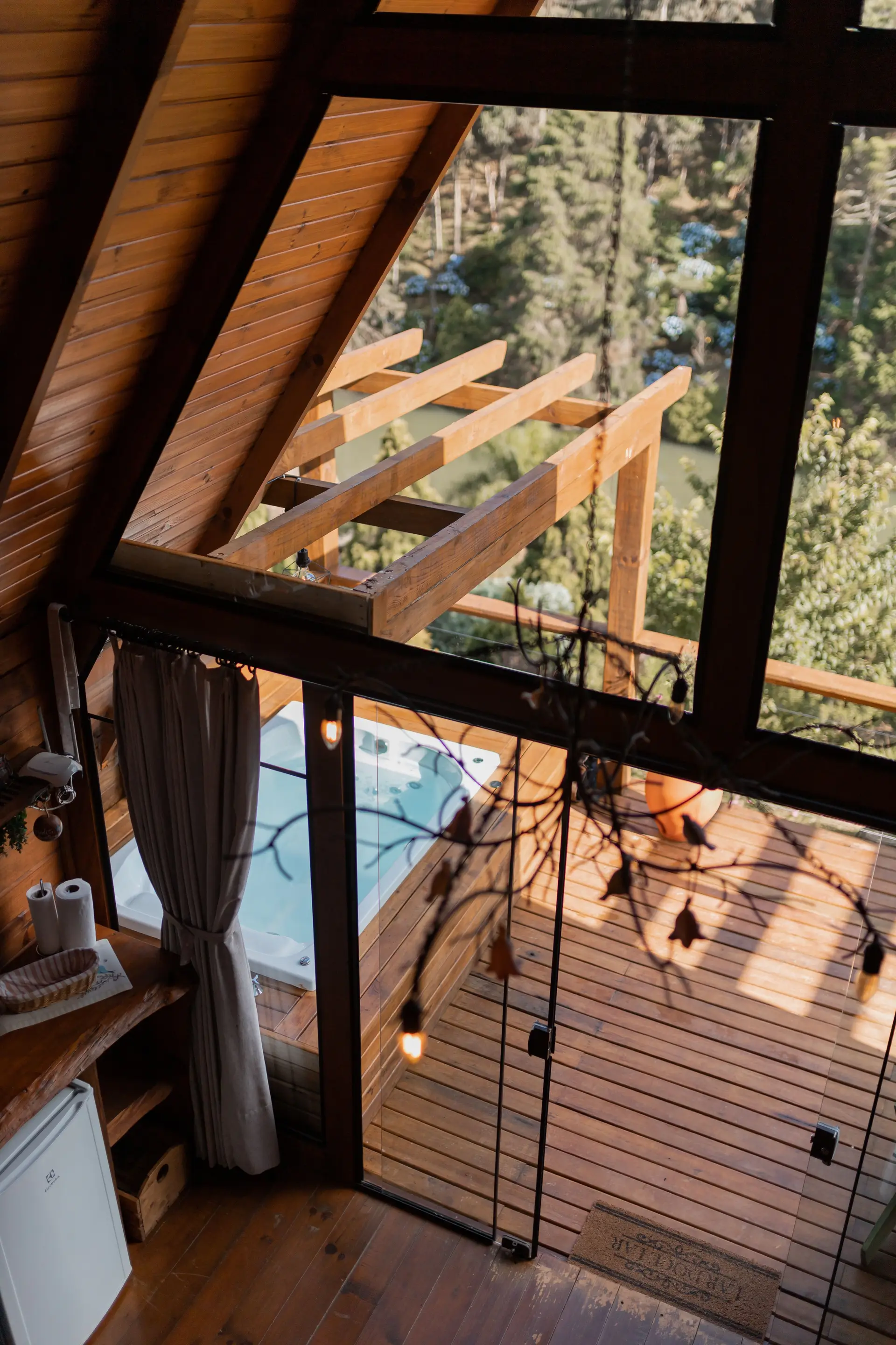 Sunlit outdoor balcony and rustic wooden interior of woodland retreat sanctuary