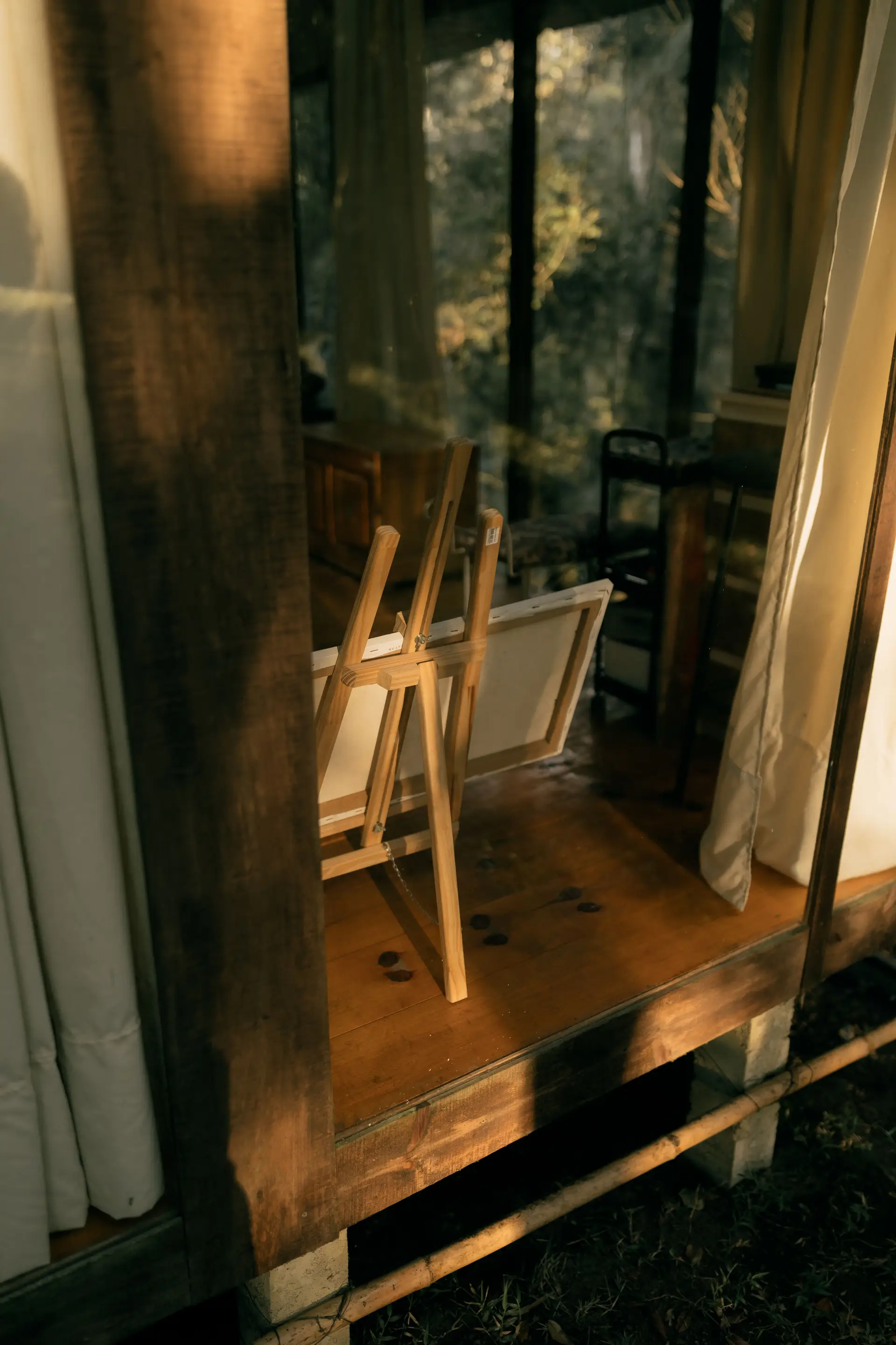 Forest Suite interior with warm natural wooden beams, soft linens, and panoramic tree canopy view