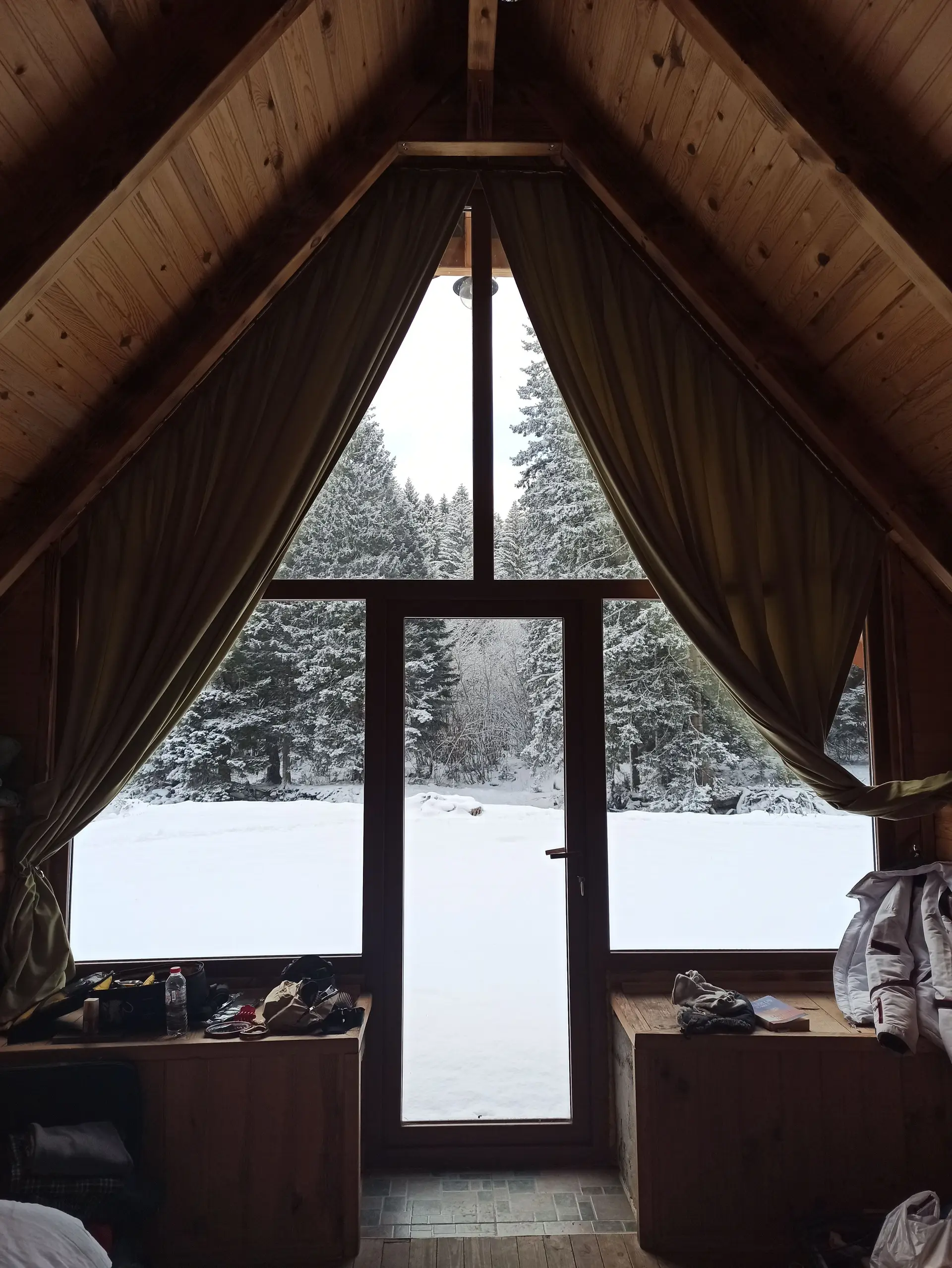 Lakeside Cabin living space looking out over quiet water and pine-covered ridges